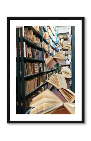 Flying books on library bookshelves background