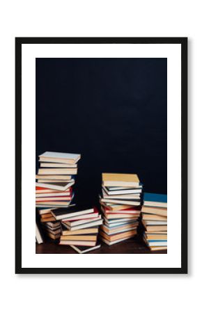 lots of stacks of educational books to teach at the college library on a black background