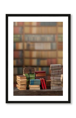 Stacks of many books on a shelf or table. Concept of library, reading, old classic literature