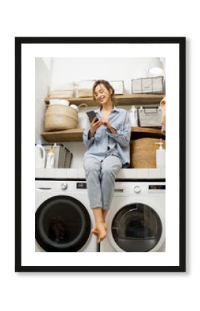 Woman with phone in the laundry room