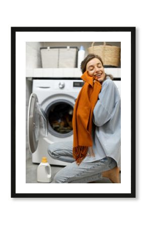 Housewife with fresh cleaned scarf in the laundry room at home