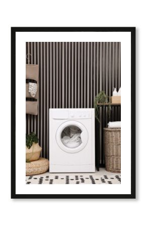 Stylish laundry room interior with washing machine