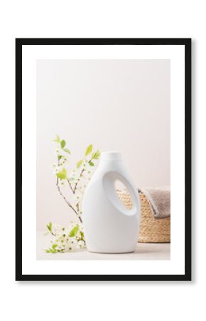 Eco-friendly white detergent bottle and Clean towel in wicker basket. Eco-friendly laundry concept