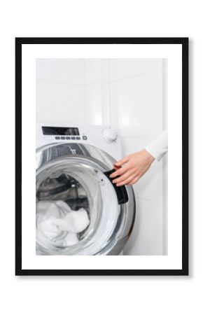 laundry at home, woman load washing machine and close door