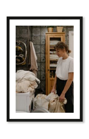 Woman with laundry in bathroom 