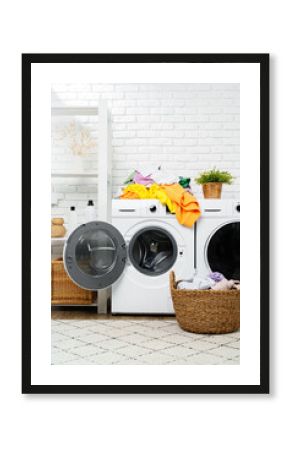 Pile of Laundry Awaiting Washing Machine in White Brick Laundry Room