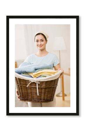 Housewife holding full basket of laundry