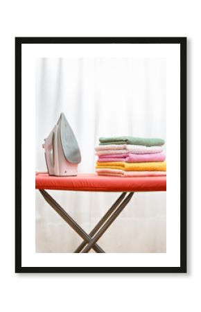 iron and laundry on the ironing board