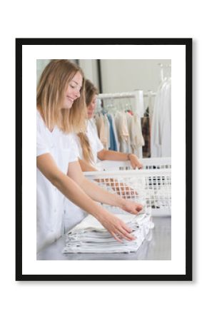 Professional women folding laundry
