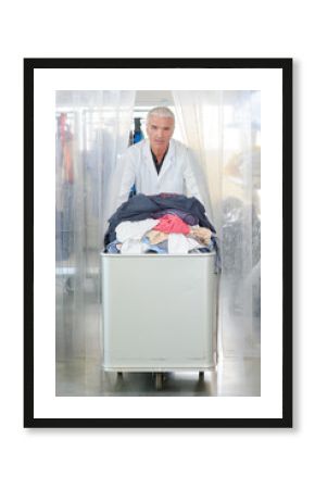 Man pushing trolley of laundry