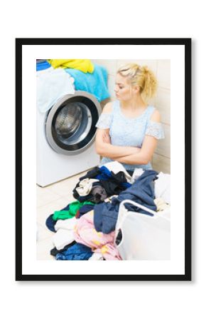 Unhappy woman having a lot of laundry