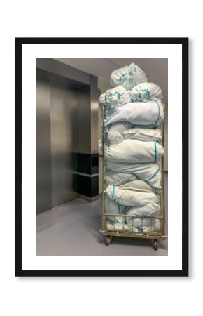 Collected laundry bags in the hospital are transported in a transport box. Concept: Health and hygiene