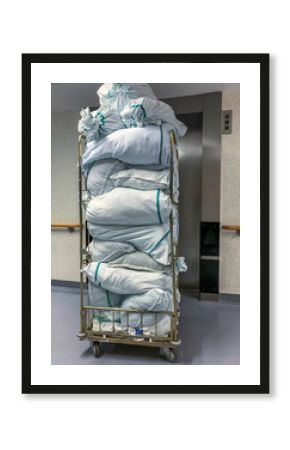 Collected laundry bags in the hospital are transported in a transport box. Concept: Health and hygiene