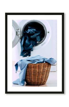 Close up washing machine and clothes in basket on white background. Laundry concept.