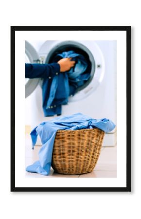 Close up washing machine and clothes in basket on white background. Laundry concept.