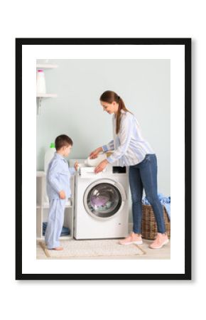 Young woman with her little son doing laundry at home