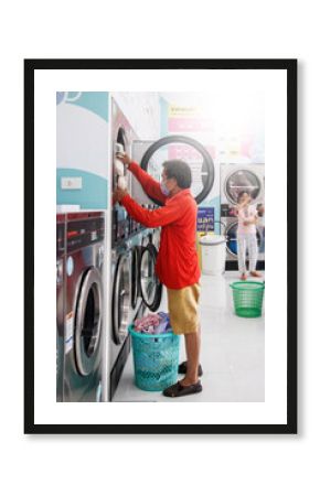 Asia people washing clothes at the laundry shop. 