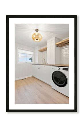 White laundry room with a washer and dryer
