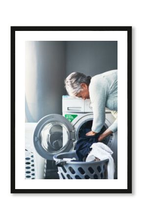 Lets get down to laundering business. Shot of a mature woman doing laundry at home.