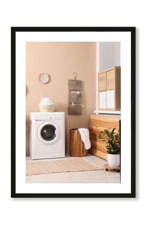 Stylish laundry room with modern washing machine. Interior design