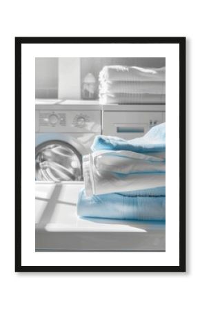 A stack of blue towels sits neatly folded on the top of a white washing machine, showcasing a clean and organized laundry room. Generative AI