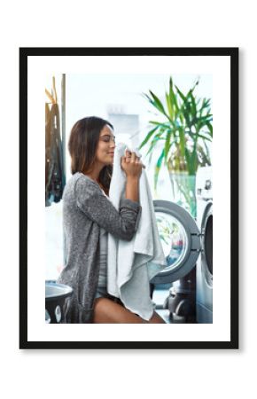 Woman, smell laundry and washing machine for clean towel in home, hygiene and fresh soap aroma. Female person, breathe and housework tasks on morning, check fabric and dryer for fragrance scent