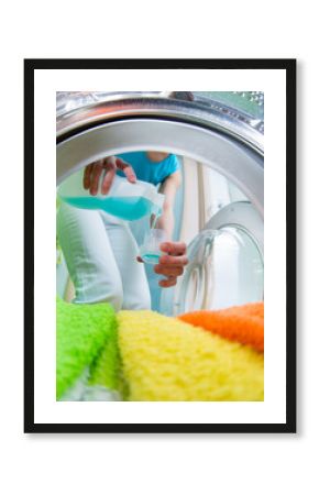 householder woman using conditioner for  washing machine