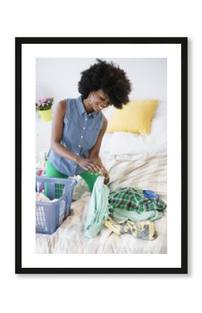 Mixed race woman folding laundry