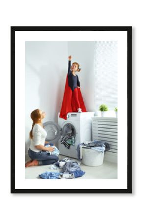 family mother and child little superhero helper in laundry room