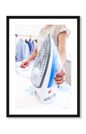 close up hand of woman ironing clothes on the table