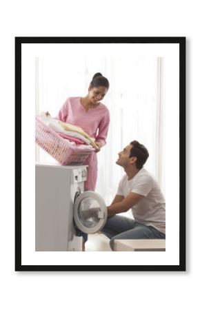 Young couple doing laundry