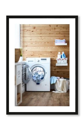 Interior of real laundry room with  washing machine at window at home