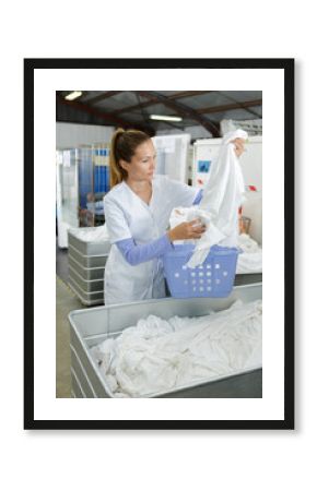 young beautiful female working at industrial laundry