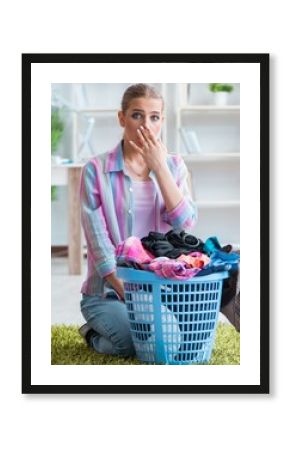 Tired depressed housewife doing laundry