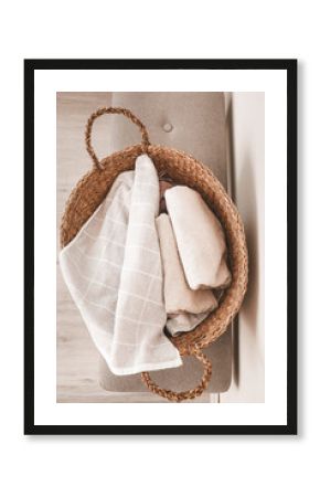 Wicker basket with clean towels in laundry room
