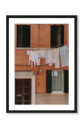 The laundry drying on a clothesline against old European building.