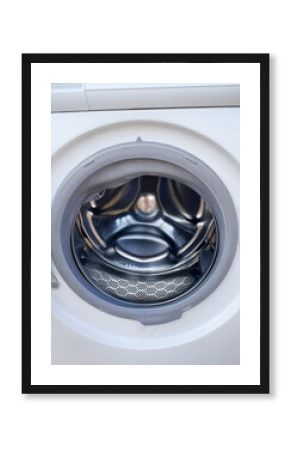 Stainless steel washing machine drum, capturing the rhythmic dance of laundry on National Clean Your Closet Day, zen-like domesticity