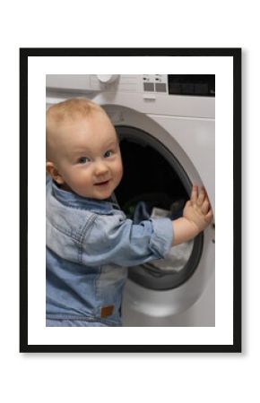 Smiling little child doing laundry.