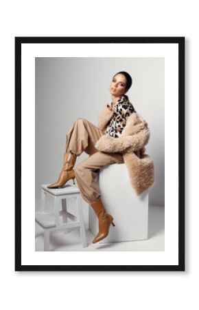 woman with bright makeup on her face brown boots fashion leopard shirt