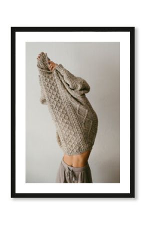 Teenage inside a big wool sweater