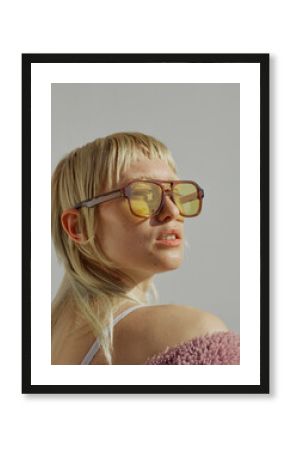 A confident young woman is wearing a big fashion sunglasses 