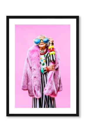 Cool and stylish senior old woman with fashionable clothes - Funny colorful portrait of elderly female lady on colored background