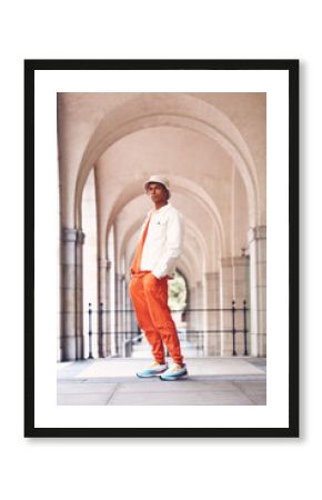 Fashion portrait, cool and black man posing in a city arch building. Stylish lifestyle, retro and handsome creative person or designer model in fashionable, fancy and edgy hat, shirt and pants.