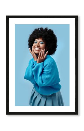 African beauty, makeup and portrait of a black woman with blue eyes shadow, face cosmetics and afro hair or good skin. Funk, smile and young happy girl with vintage, retro and creative fashion style.