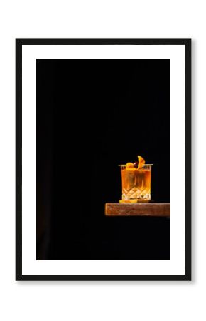 old fashioned cocktail on a wooden table and black background