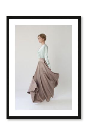 Studio shot of female fashion model in beige maxi circle skirt, Simplistic and elegant silk satin full length skirt