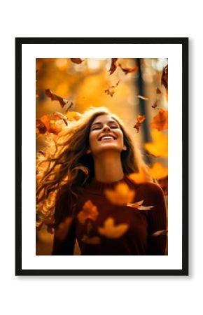 Joyful smiling Woman with falling leaves in a park in the autumn. Colors are warm orange and yellow. Concept of fall colors, fashion and happiness. Shallow field of view.