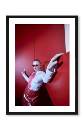 Vertical fisheye fashion portrait of confident young woman posing in red set, copy space