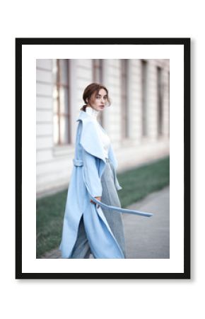 young beautiful stylish woman walking in street in blue coat, autumn fashion trend, smiling, happy.