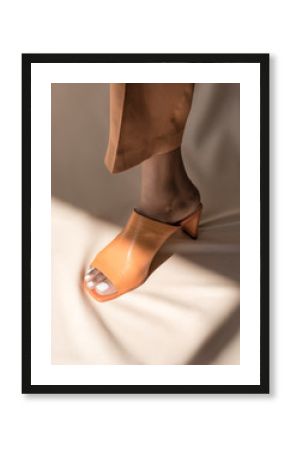Stepping into the light, high fashion female model foot
